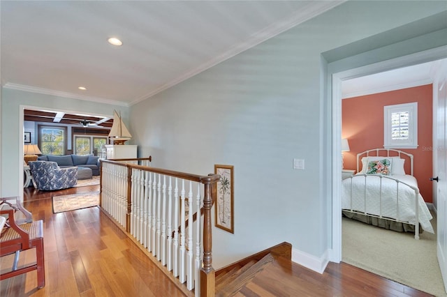 5616 Seagrass Pl, Apollo Beach, FL 33572 - hallway with baseboards, wood finished floors, an upstairs landing, and crown molding