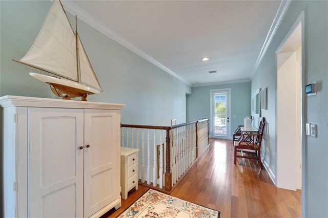 5616 Seagrass Pl, Apollo Beach, FL 33572 - corridor with baseboards, ornamental molding, visible vents, and light wood-style floors