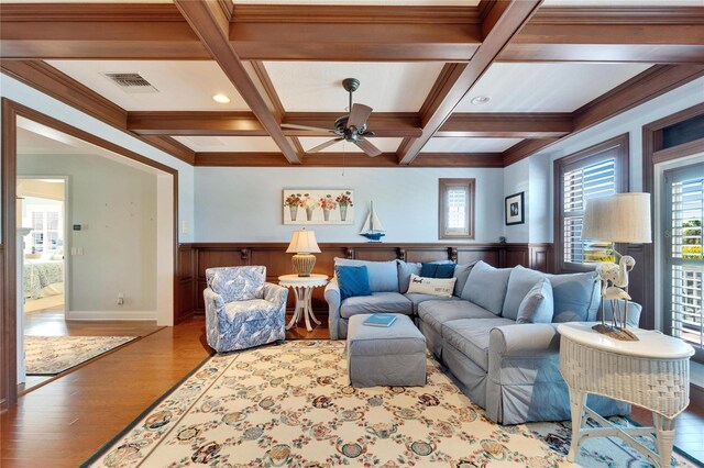5616 Seagrass Pl, Apollo Beach, FL 33572 - living room featuring a wainscoted wall, visible vents, wood finished floors, coffered ceiling, and beamed ceiling