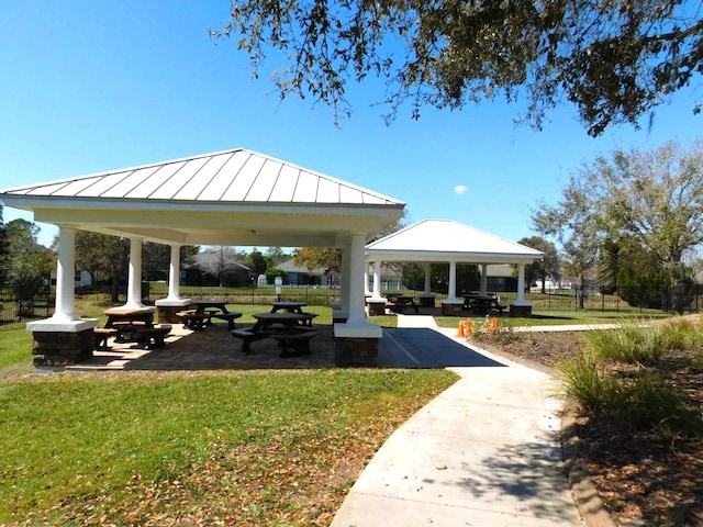 view of property's community featuring a yard, fence, and a gazebo