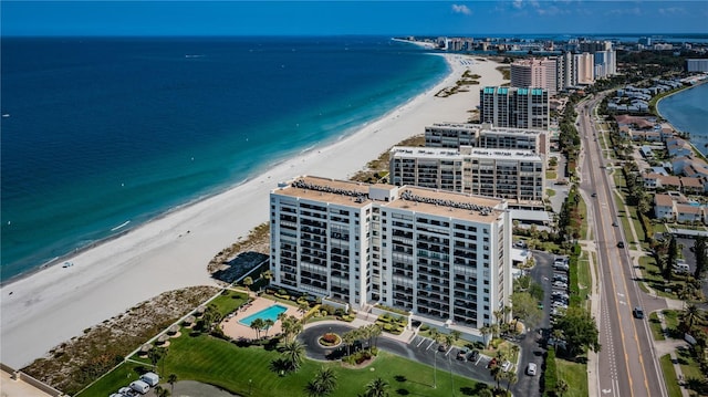 birds eye view of property with a water view, a view of city, and a beach view