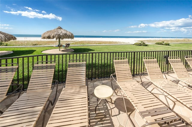 wooden terrace featuring a lawn and a water view