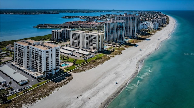 aerial view featuring a city view, a view of the beach, and a water view