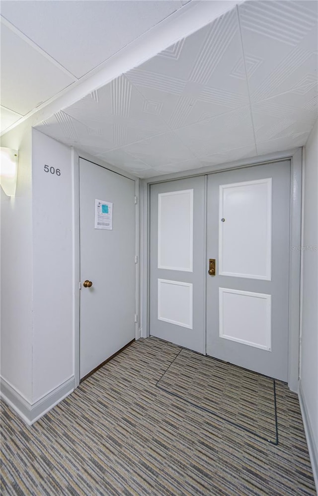 foyer entrance with carpet flooring