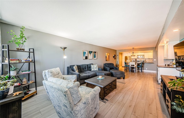 living room featuring light wood-type flooring and baseboards