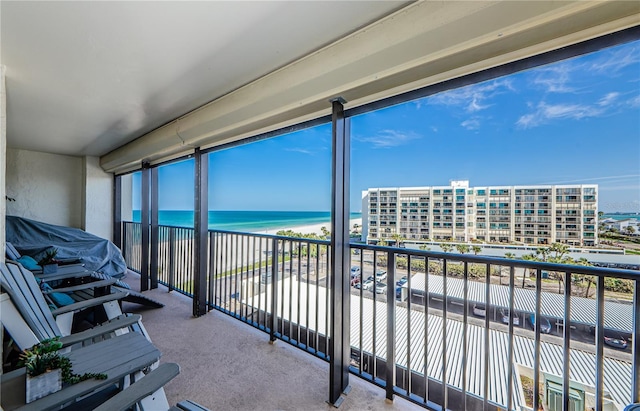 balcony with a water view and a beach view