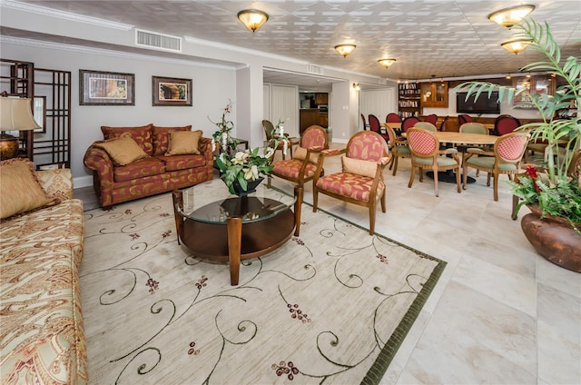 living area featuring visible vents, baseboards, and ornamental molding