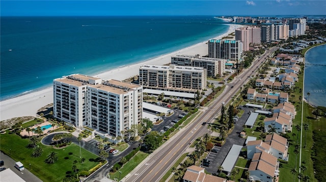 bird's eye view featuring a water view, a view of city, and a beach view