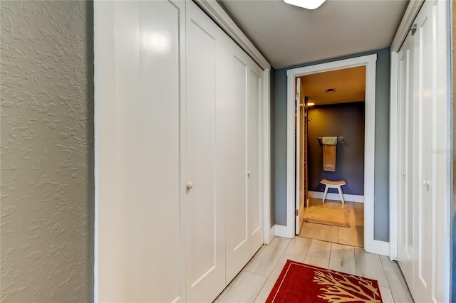 1460 Gulf Blvd Unit 506, Clearwater Beach, FL 33767 - hallway featuring a textured wall and light tile patterned flooring