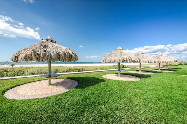 1460 Gulf Blvd Unit 506, Clearwater Beach, FL 33767 - surrounding community featuring a gazebo, view of water and beach, and a lawn