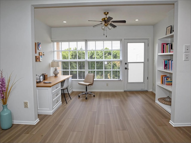 office space featuring ceiling fan, a healthy amount of sunlight, and light wood-style floors