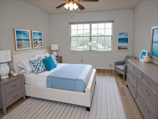 bedroom with light wood-type flooring, baseboards, and ceiling fan