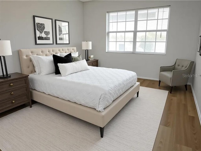 bedroom featuring light wood-style flooring and baseboards