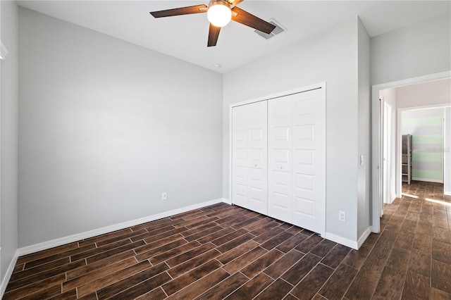 unfurnished bedroom featuring visible vents, dark wood finished floors, and baseboards