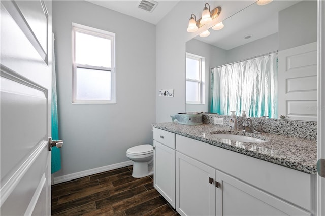 full bath with visible vents, baseboards, toilet, wood tiled floor, and vanity