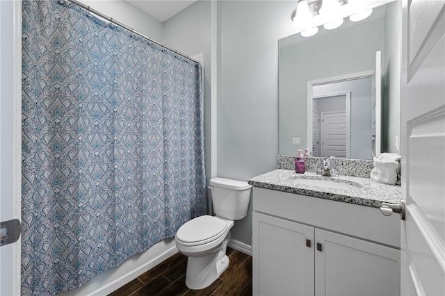 full bath featuring shower / tub combo, baseboards, toilet, wood tiled floor, and vanity