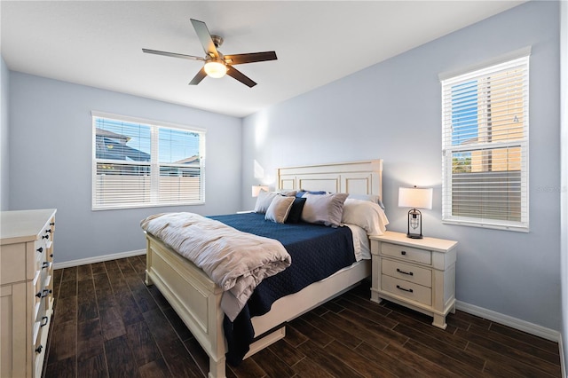 bedroom featuring ceiling fan, baseboards, and dark wood finished floors