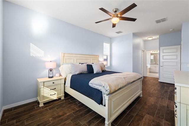 bedroom with wood tiled floor, visible vents, connected bathroom, and baseboards