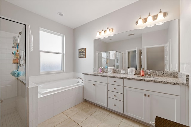 full bath with double vanity, a sink, tile patterned flooring, a shower stall, and a bath