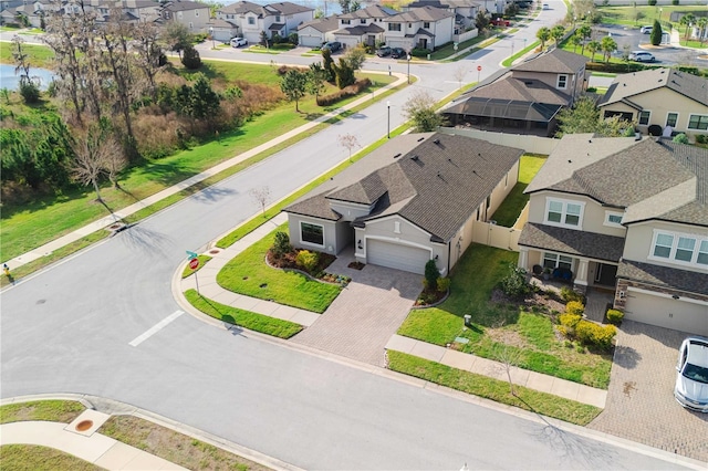 drone / aerial view featuring a water view and a residential view