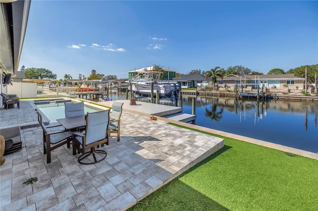 exterior space with outdoor dining area, boat lift, a water view, a boat dock, and fence