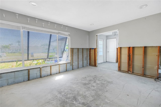 unfurnished room featuring concrete flooring