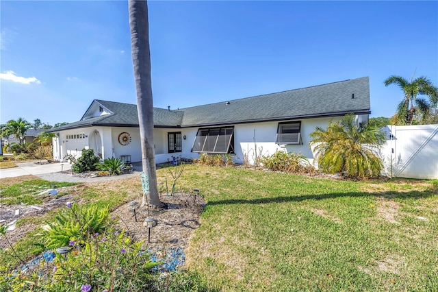 single story home featuring concrete driveway, stucco siding, an attached garage, a gate, and a front yard