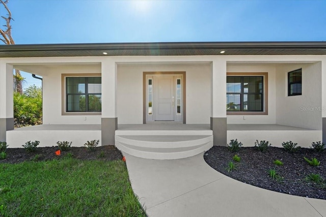 view of front of house with covered porch and stucco siding