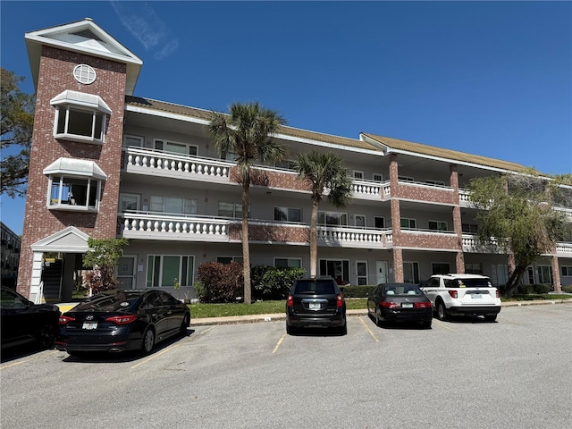 view of building exterior featuring uncovered parking