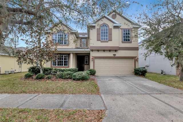 traditional home featuring a garage, a front yard, driveway, and stucco siding