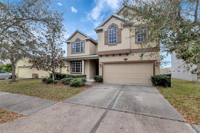 traditional-style home featuring an attached garage, driveway, a front lawn, and stucco siding