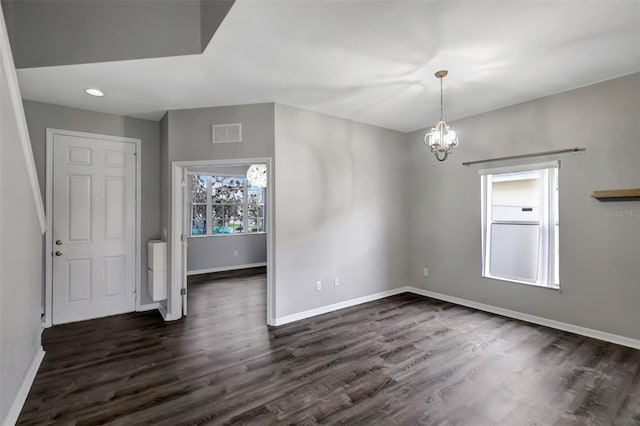 interior space with dark wood finished floors, recessed lighting, visible vents, an inviting chandelier, and baseboards