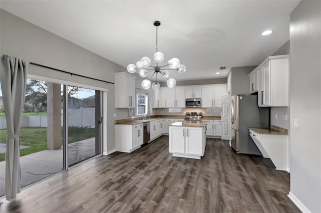 kitchen featuring a kitchen island, baseboards, white cabinets, appliances with stainless steel finishes, and dark wood finished floors