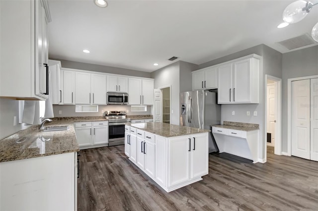 kitchen featuring a sink, visible vents, white cabinets, appliances with stainless steel finishes, and light stone countertops