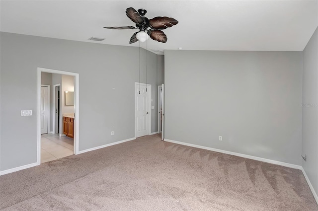 unfurnished bedroom featuring light carpet, ensuite bath, visible vents, and baseboards