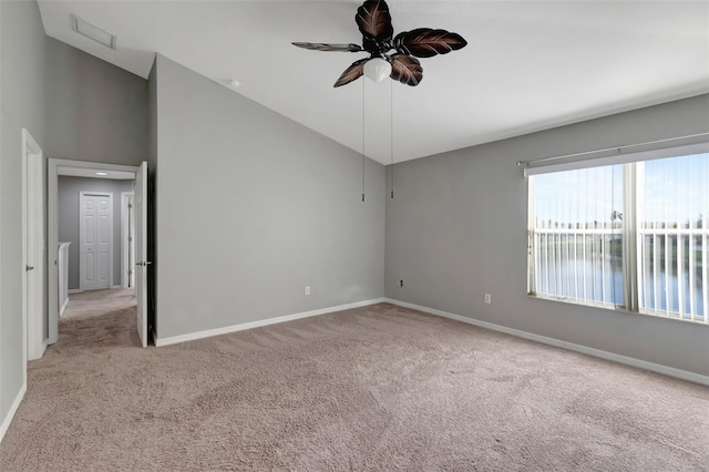 spare room featuring high vaulted ceiling, a ceiling fan, baseboards, and carpet flooring