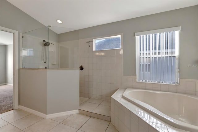 full bath featuring tile patterned floors, a garden tub, baseboards, and walk in shower