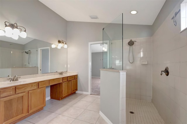 bathroom featuring double vanity, lofted ceiling, a sink, a walk in shower, and tile patterned floors