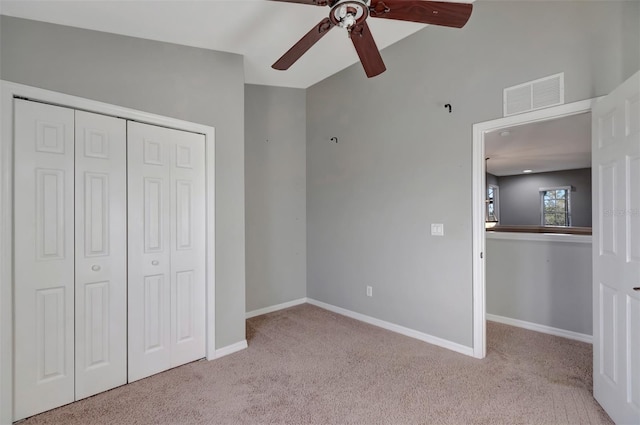 unfurnished bedroom featuring carpet floors, a closet, visible vents, and baseboards