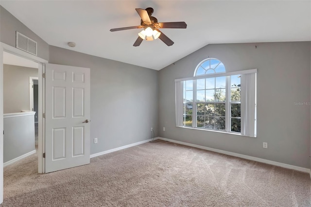 unfurnished room with baseboards, visible vents, lofted ceiling, ceiling fan, and carpet flooring