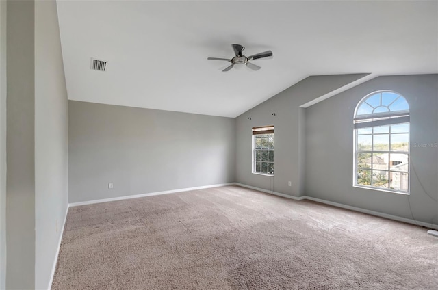 unfurnished room featuring vaulted ceiling, carpet flooring, visible vents, and baseboards