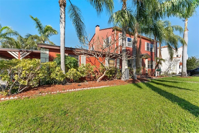 rear view of property with a lawn