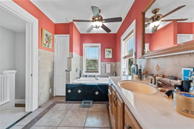 full bathroom featuring vanity, ornamental molding, tile patterned flooring, a garden tub, and tile walls