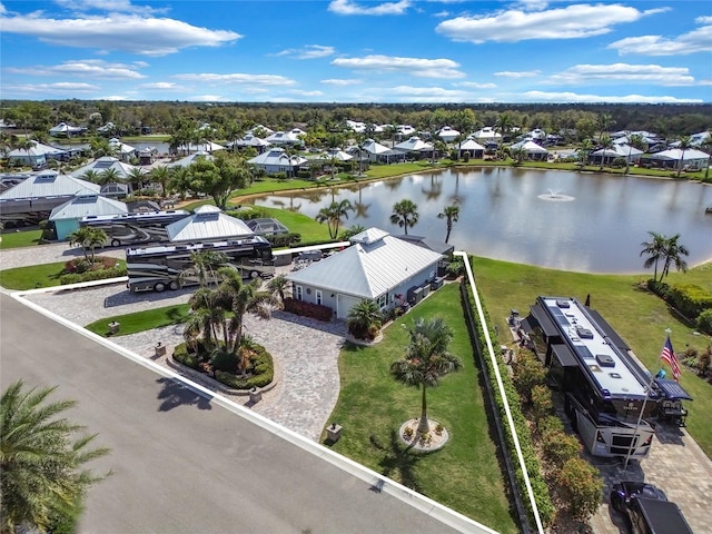 drone / aerial view with a water view and a residential view