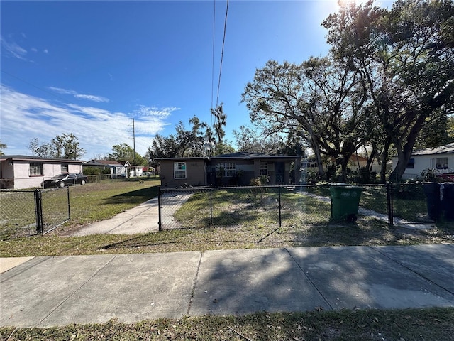 view of front of house with a fenced front yard, a front yard, and a gate