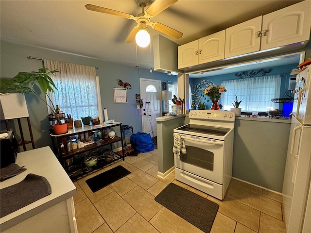 kitchen featuring light tile patterned floors, ceiling fan, white cabinets, electric stove, and light countertops