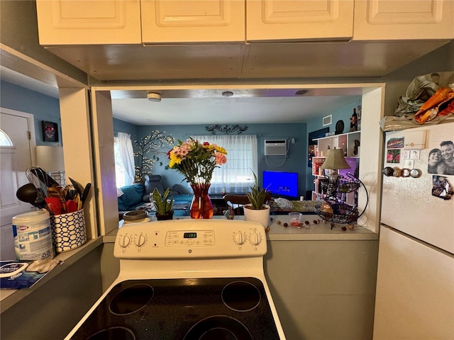 interior space featuring white appliances and a wall unit AC