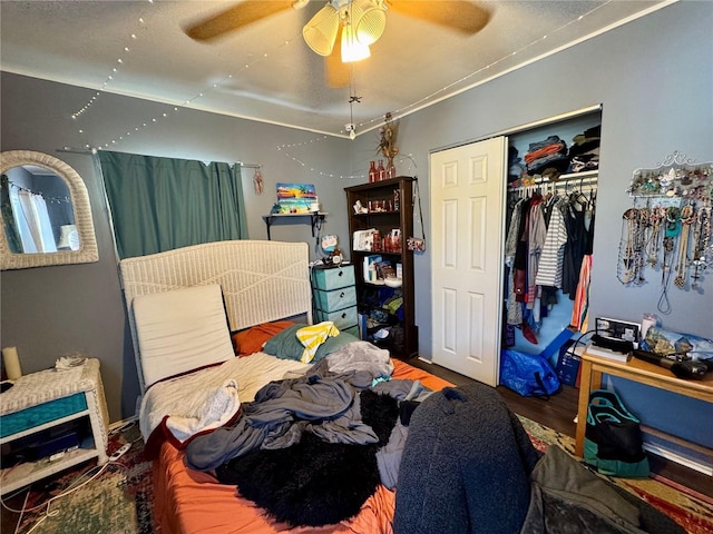 bedroom with a closet, wood finished floors, and a ceiling fan