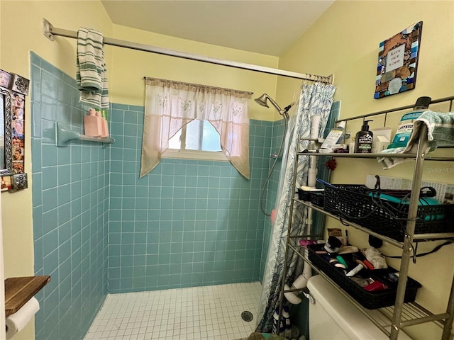 bathroom featuring a shower stall and toilet