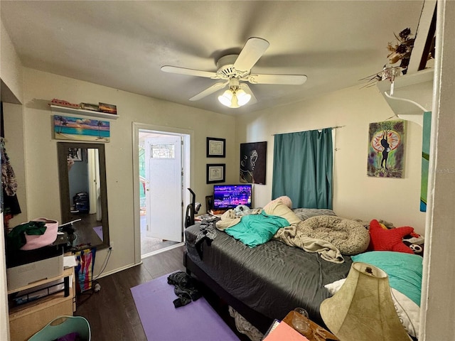 bedroom with a ceiling fan and wood finished floors